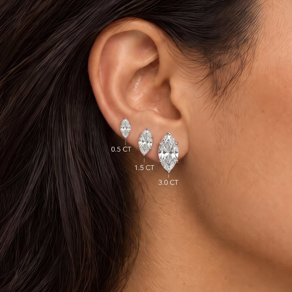 Marquise cut lab grown diamond stud earrings worn in 0.5, 1.5 and 3.0 carat sizes