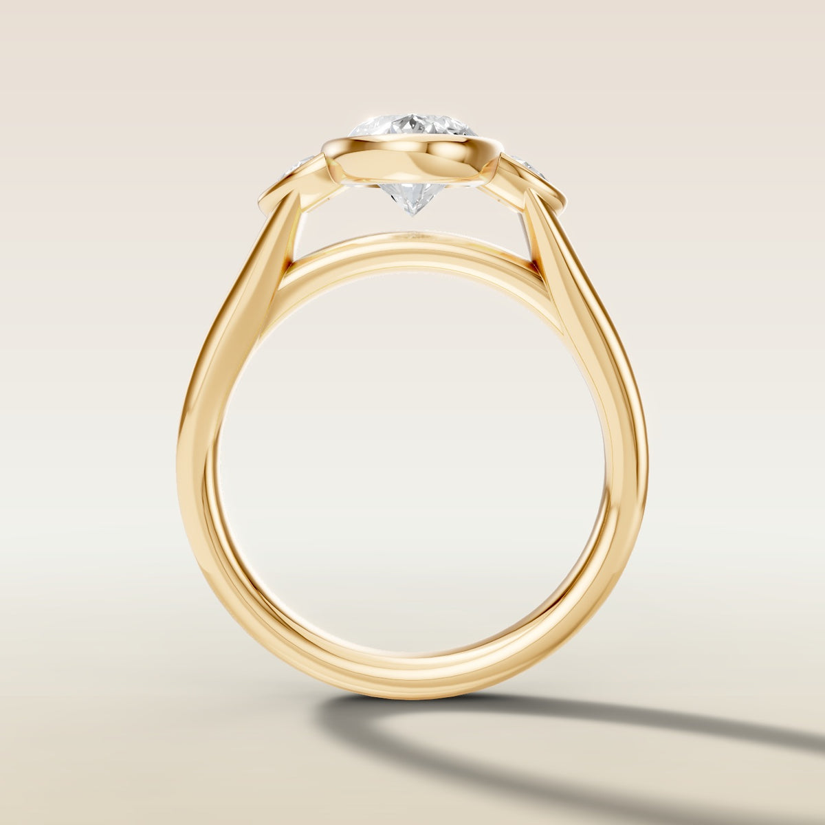 Moval Three Stone Full Bezel engagement ring in yellow gold, front view