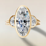 Moval Three Stone Full Bezel engagement ring in yellow gold, top view