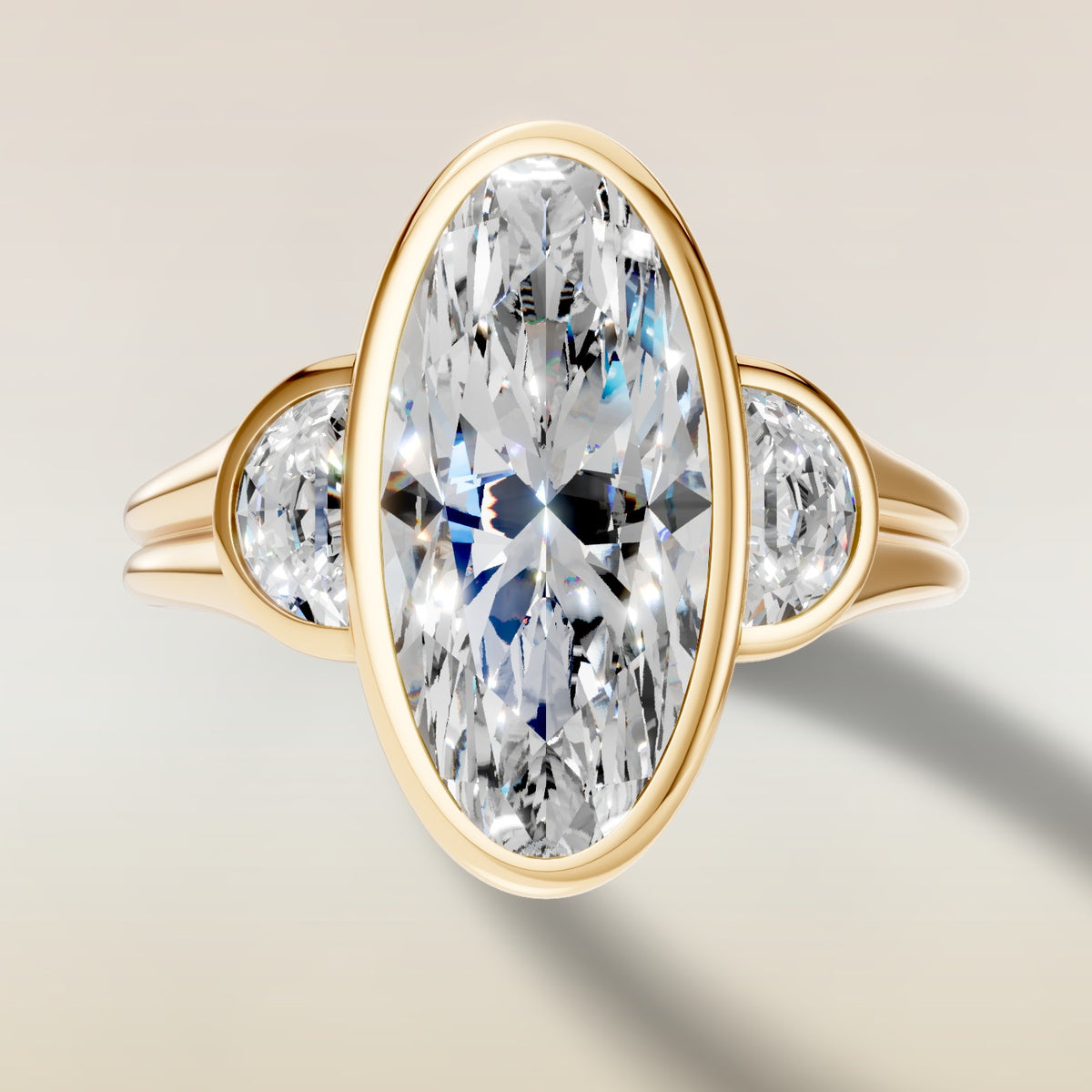 Moval Three Stone Full Bezel engagement ring in yellow gold, top view