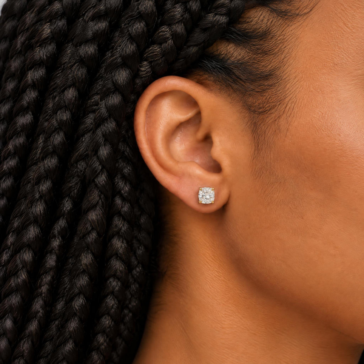 Cushion diamond stud earring worn on the ear