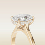 Oval Four Petal Tulip Curved Hidden Halo engagement ring in yellow gold, basket close up