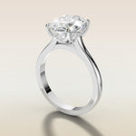 Oval Four Petal Tulip Curved Hidden Halo engagement ring in white gold, angled side view