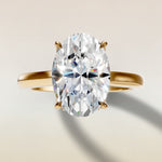 Oval Four Petal Tulip Curved Hidden Halo engagement ring in yellow gold, top view