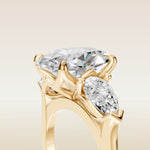 Oval Four Petal Tulip Three Stone engagement ring in yellow gold, basket close up