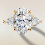Oval Four Petal Tulip Three Stone engagement ring in yellow gold, top view