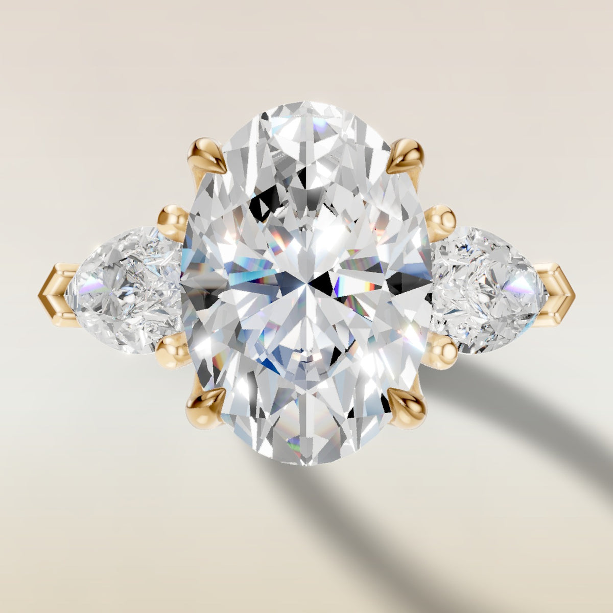 Oval Four Petal Tulip Three Stone engagement ring in yellow gold, top view