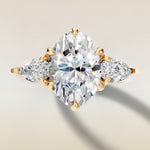 Oval Six Petal Tulip Three Stone engagement ring in yellow gold, top view