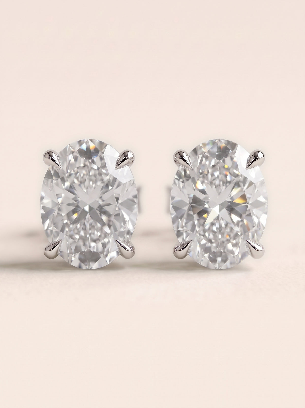 Oval diamond stud earrings in 14K white gold