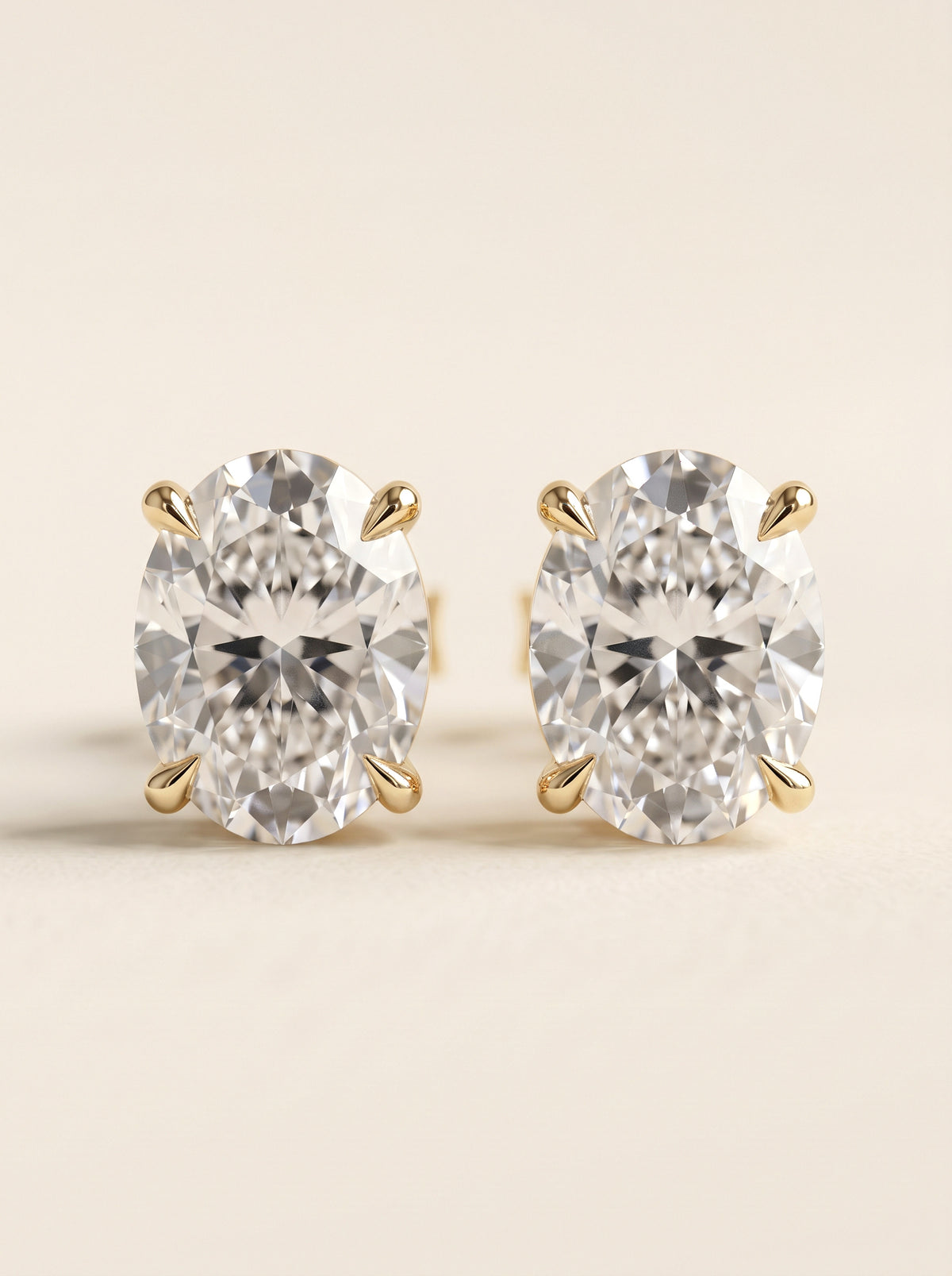 Oval diamond stud earrings in 14K yellow gold