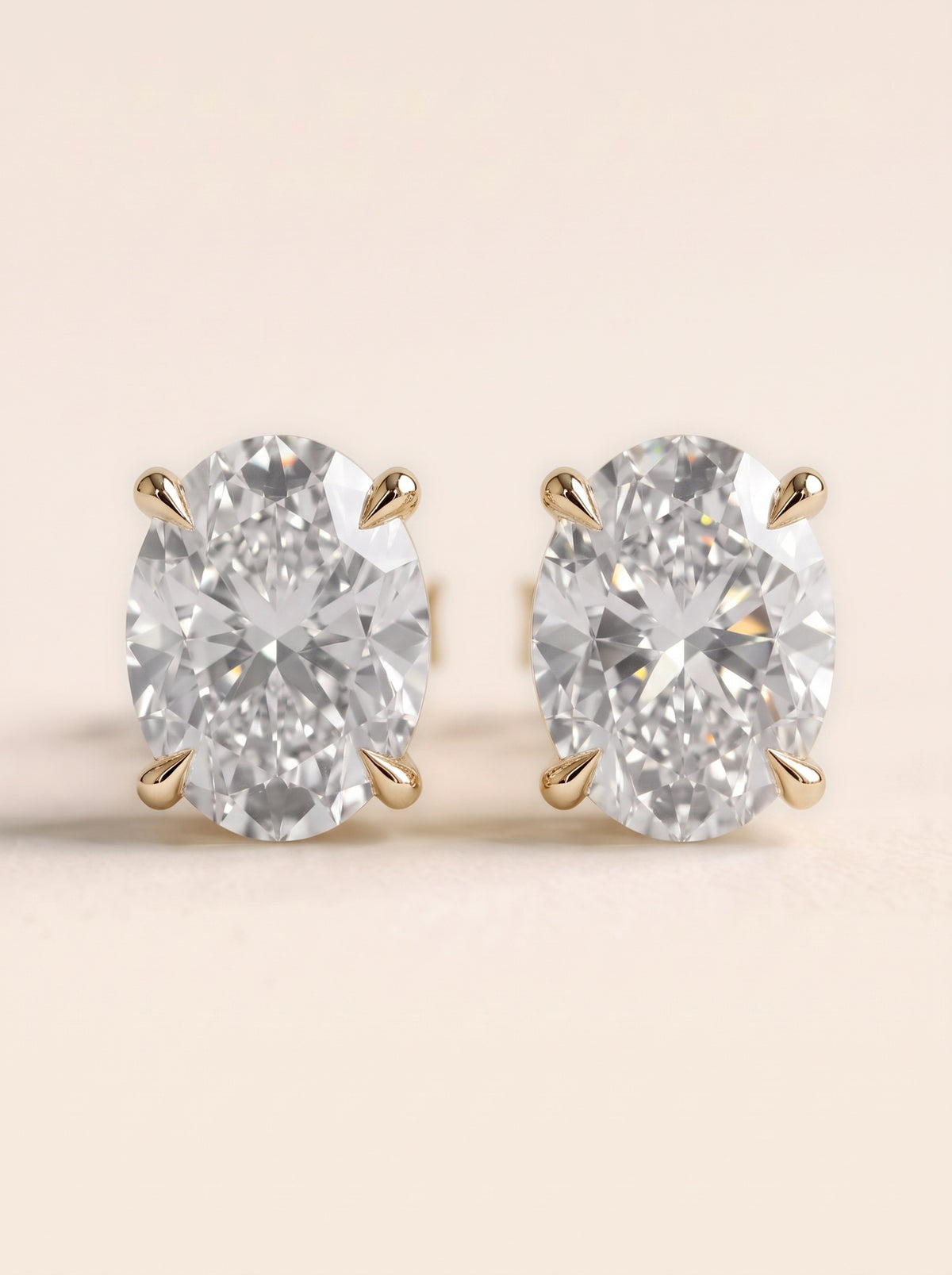 Oval diamond stud earrings in 14K yellow gold