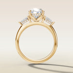Oval Tulip Three Stone Hidden Halo engagement ring in yellow gold, front view