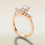 Oval Tulip Three Stone Hidden Halo engagement ring in rose gold, angled side view