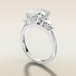 Oval Tulip Three Stone Hidden Halo engagement ring in white gold, angled side view