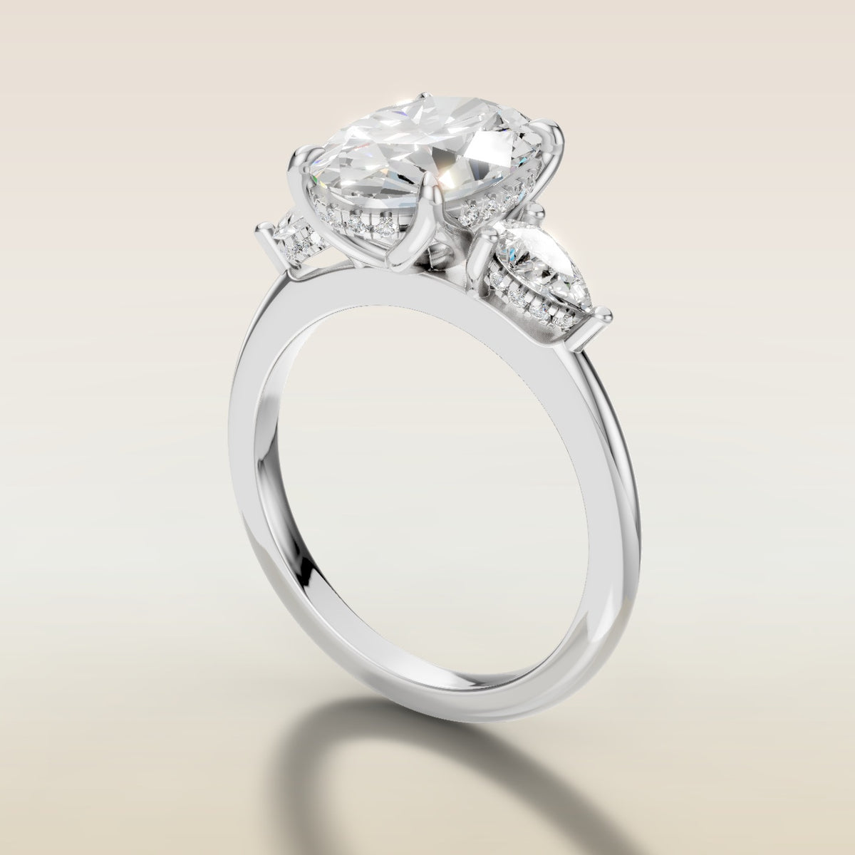 Oval Tulip Three Stone Hidden Halo engagement ring in white gold, angled side view