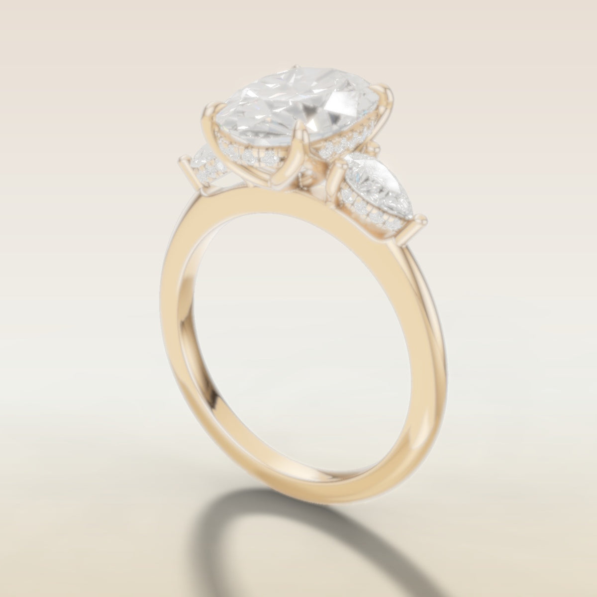 Oval Tulip Three Stone Hidden Halo engagement ring in yellow gold, angled side view
