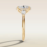 Oval Tulip Three Stone Hidden Halo engagement ring in yellow gold, side profile
