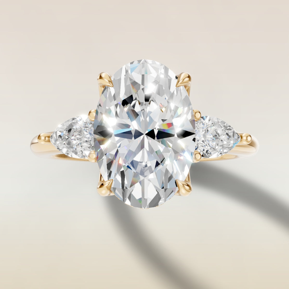 Oval Tulip Three Stone Hidden Halo engagement ring in yellow gold, top view