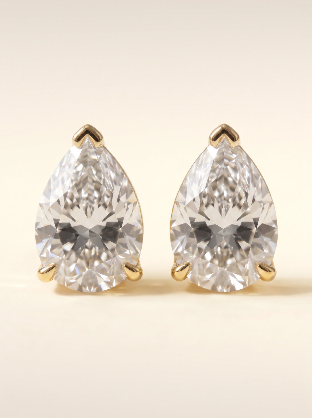 Pear diamond stud earrings in 14K yellow gold