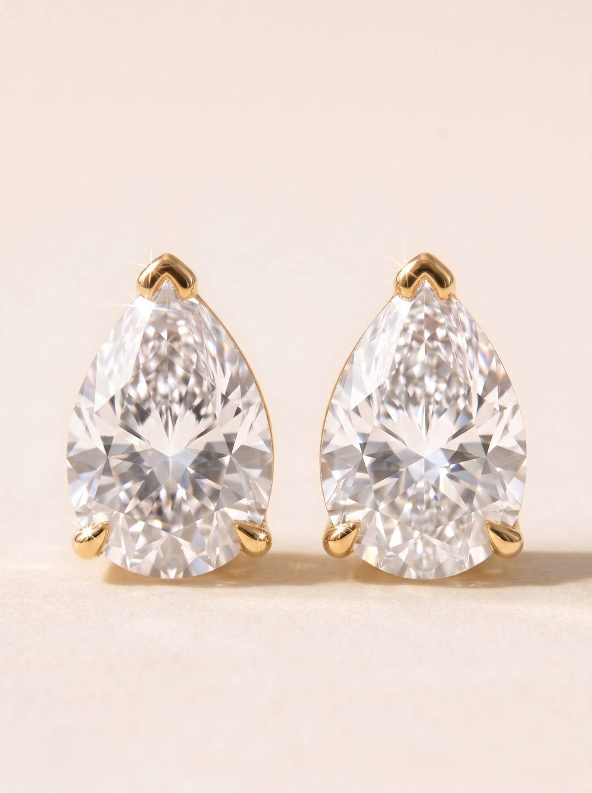 Pear diamond stud earrings in 14K yellow gold