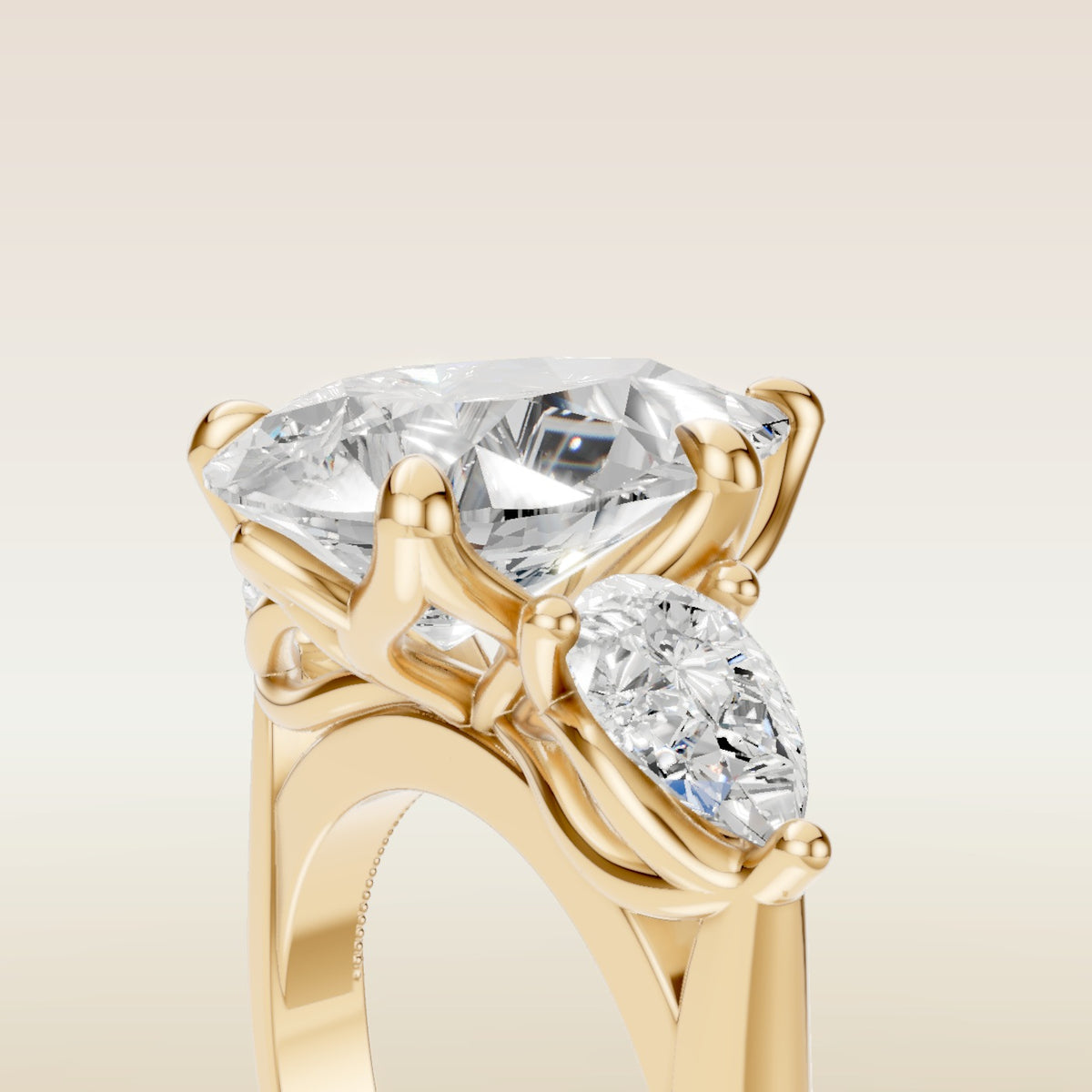 Pear Tulip Three Stone Diamond Bridge engagement ring in yellow gold, basket close up