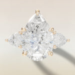 Pear Tulip Three Stone Diamond Bridge engagement ring in yellow gold, top view