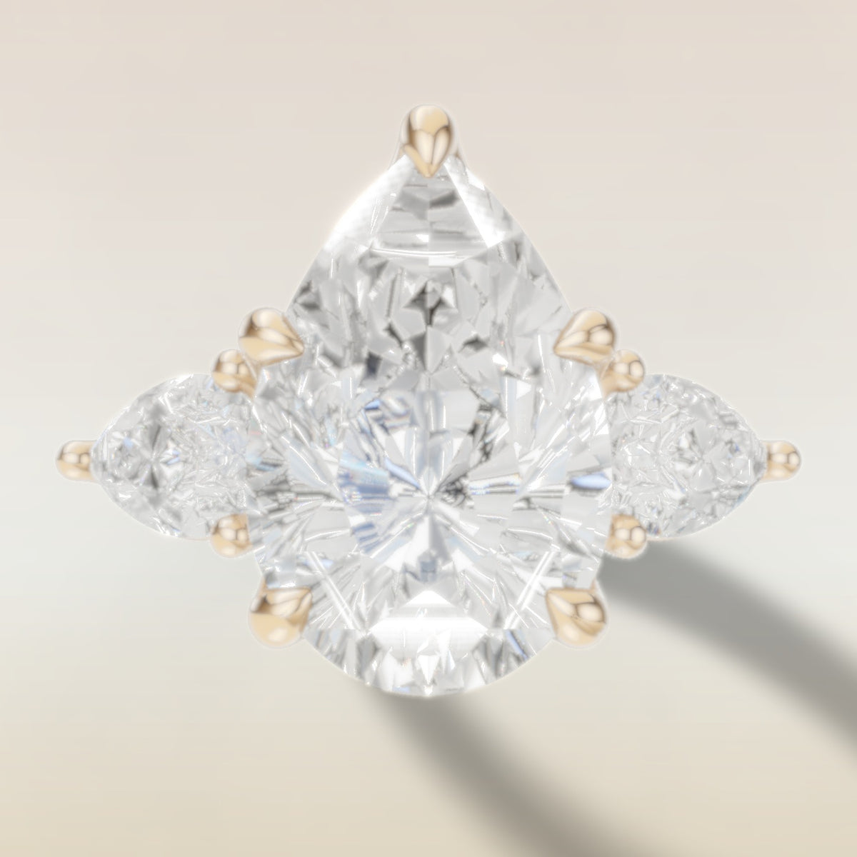 Pear Tulip Three Stone Diamond Bridge engagement ring in yellow gold, top view