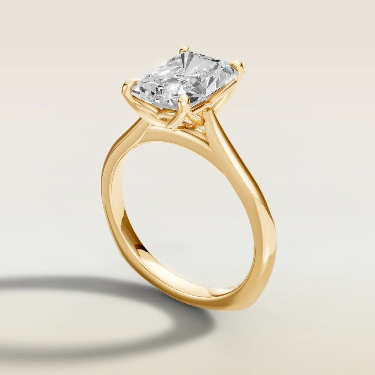Radiant tulip engagement ring with curved gallery rail in yellow gold, side view