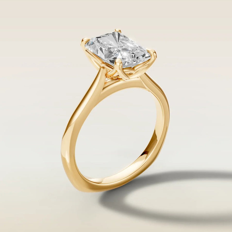 Radiant tulip engagement ring with curved gallery rail in yellow gold, side view