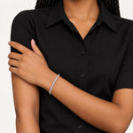 Round diamond tennis bracelet worn on the wrist