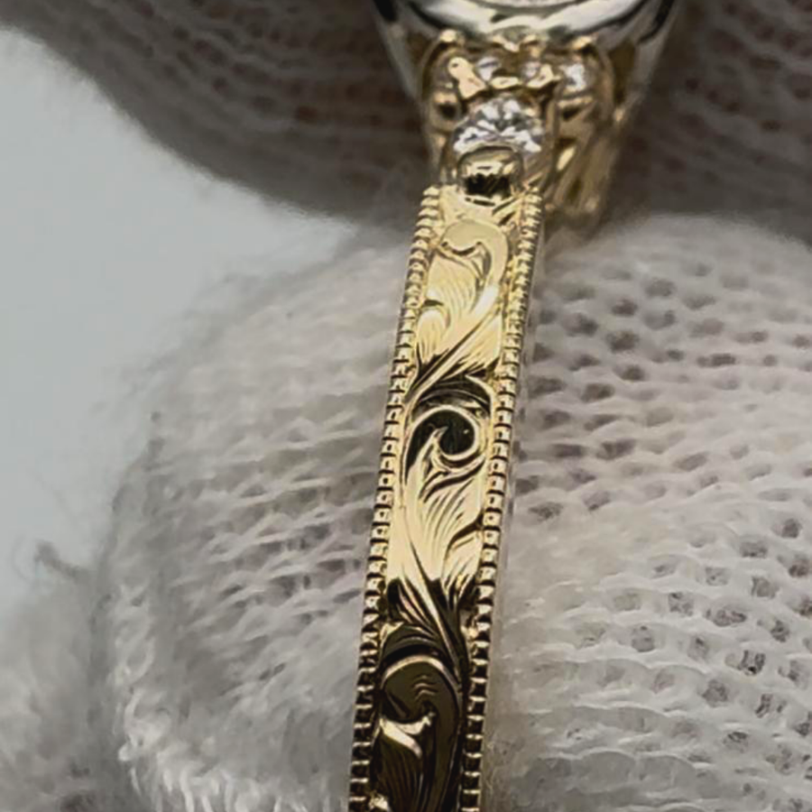 Scroll and leaf engraving on a yellow gold band with a milgrain edge